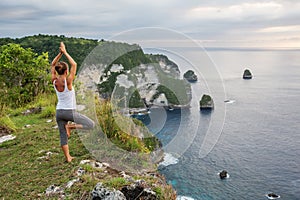 Caucasian woman practicing yoga at seashore