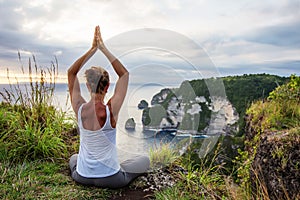 Caucasian woman practicing yoga at seashore