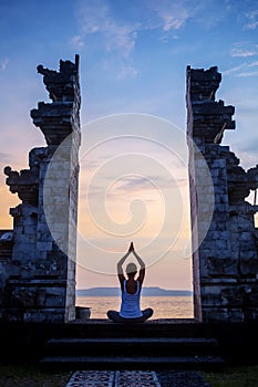 Caucasian woman practicing yoga at seashore