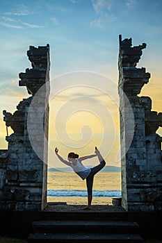 Caucasian woman practicing yoga at seashore