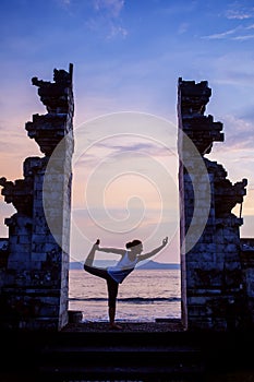 Caucasian woman practicing yoga at seashore