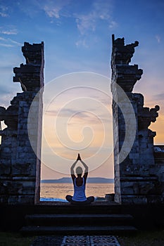 Caucasian woman practicing yoga at seashore