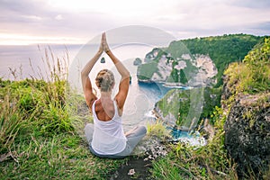 Caucasian woman practicing yoga at seashore