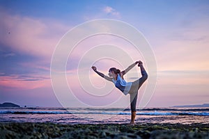 Caucasian woman practicing yoga at seashore