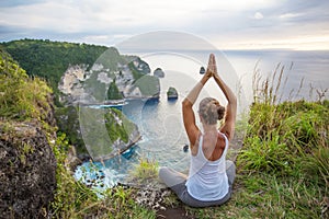 Caucasian woman practicing yoga at seashore