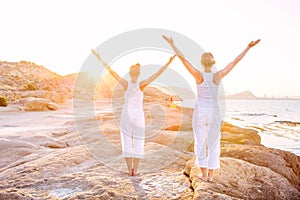 Caucasian woman practicing yoga at seashore