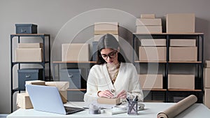 Caucasian Woman Preparing A Package For Shipment In A Warehouse