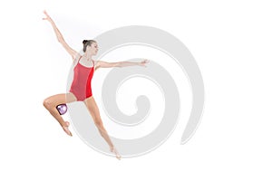 Caucasian woman rhythmic gymnast jumping with ball and looking away