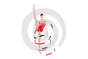 Caucasian woman rhythmic gymnast training with colorful rope