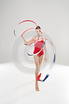 Caucasian woman rhythmic gymnast walking with colorful rope