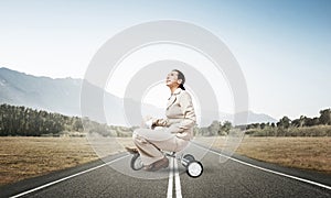 Caucasian woman riding kid& x27;s bicycle on road