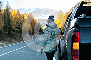 Caucasian woman on road trip enjoying mountain landscape.