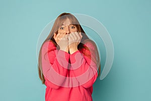 Caucasian woman& x27;s portrait isolated on blue studio background with copyspace