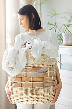 caucasian woman sorting dirty laundry basket, laundry at home