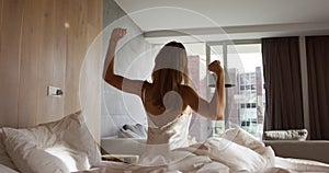 Caucasian woman stretching in hotel room