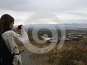 Caucasian woman taking a photo to the view from Living Room Trailhead hike