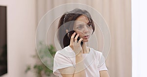 caucasian woman talking by phone at home.