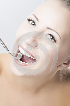 Caucasian Woman Teeth with Dental Mirror