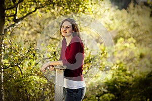 Caucasian woman thinking on wooden bridge