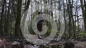 Caucasian Woman Trail Running in the Green Forest