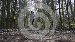 Caucasian Woman Trail Running in the Green Forest