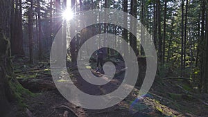 Caucasian Woman Trail Running in the Green Forest