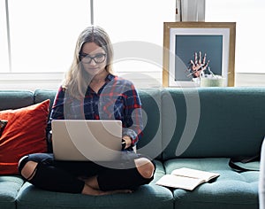 Caucasian woman using computer laptop on the couch