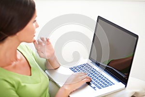 Caucasian woman using a laptop indoors