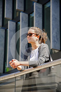 Caucasian woman Vivacious in City with a beautiful beaming smile backlit by the warm glow