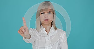 Caucasian Woman Wagging Finger on Blue Background