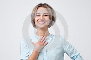 Caucasian woman wearing blue shirt smiling broadly glad to receive compliments from friends