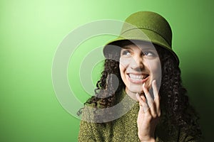 Caucasian woman wearing green clothing and hat.