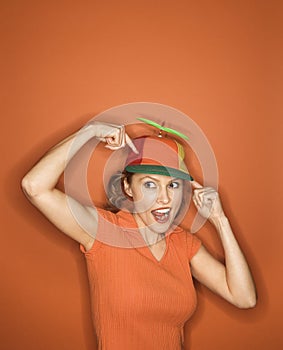 Caucasian woman wearing propeller cap.