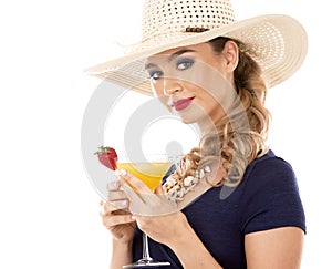 Caucasian woman wearing swimsuit, hat and holding drink