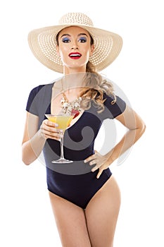 Caucasian woman wearing swimsuit, hat and holding drink