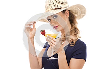 Caucasian woman wearing swimsuit, hat and holding drink