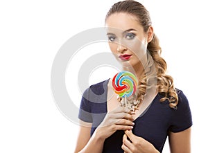 Caucasian woman wearing swimsuit, hat and holding lollypop