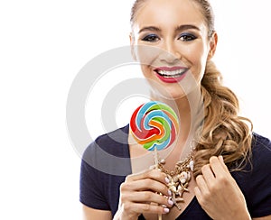 Caucasian woman wearing swimsuit, hat and holding lollypop