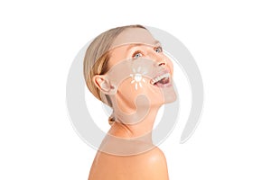 Caucasian woman with white sun on her face smiling, sun cream protection