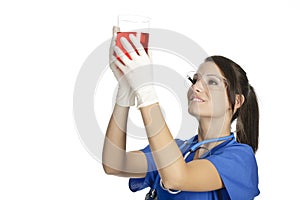 Caucasian woman working as a laboratory technician studing a beaker photo