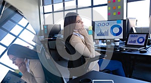 Caucasian woman working on computer and thoughtful