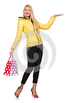 Caucasian woman in yellow jacket holding plastic bags isolated o