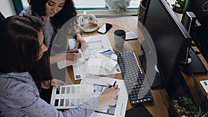 Caucasian women working on some project in the office.