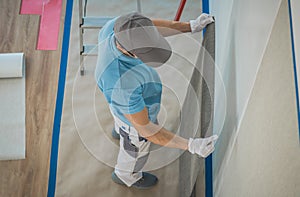 Caucasian Worker Applying Vinyl Wallpaper