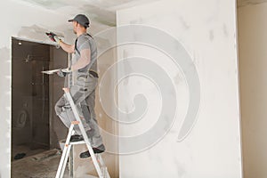 Worker Patching Drywall