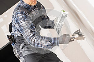 Caucasian Worker Patching Drywall