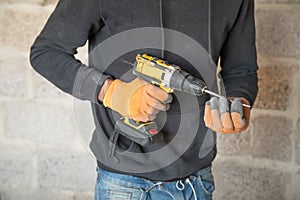 Caucasian worker using electric drill
