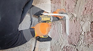 Caucasian worker using electric drill
