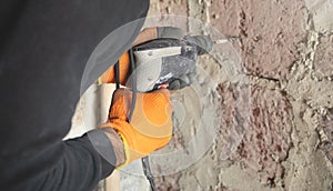 Caucasian worker using electric drill
