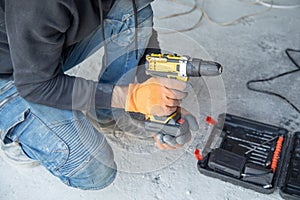 Caucasian worker using electric drill